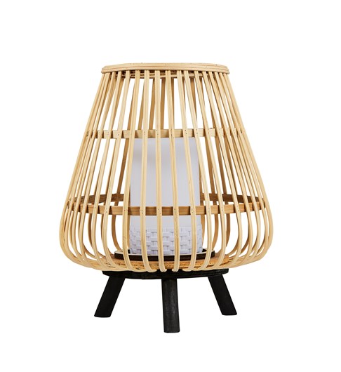 A bamboo cage style lantern style table lamp stood on a black coloured tripod base. The lantern has a white plastic pillar candle style central piece which houses a battery powered LED bulb. The light is turned off in this picture.